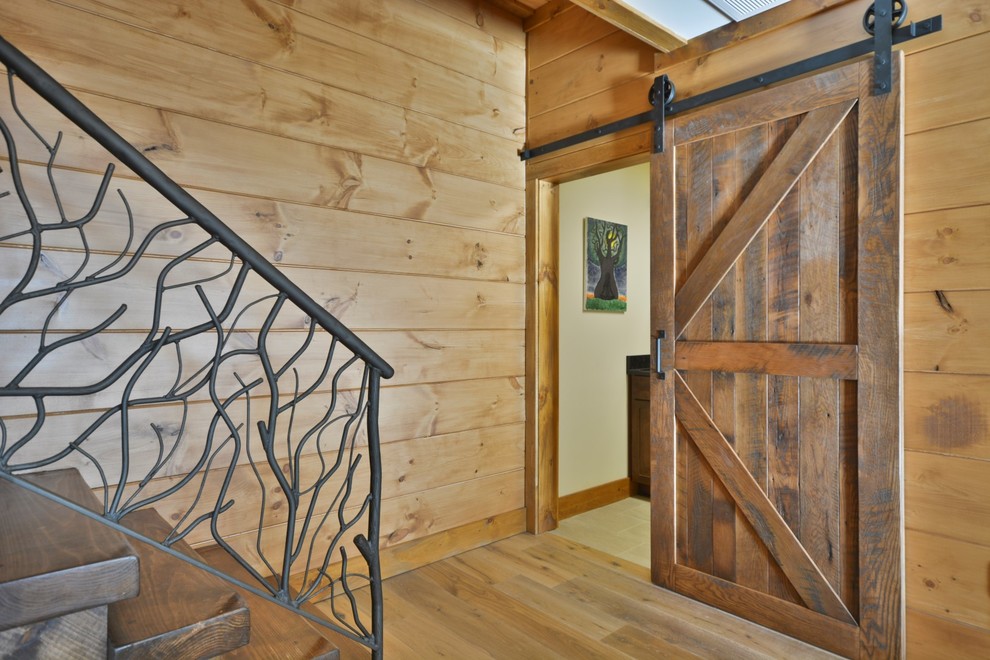 Example of a mid-sized mountain style galley and wooden l-shaped open and metal railing staircase design