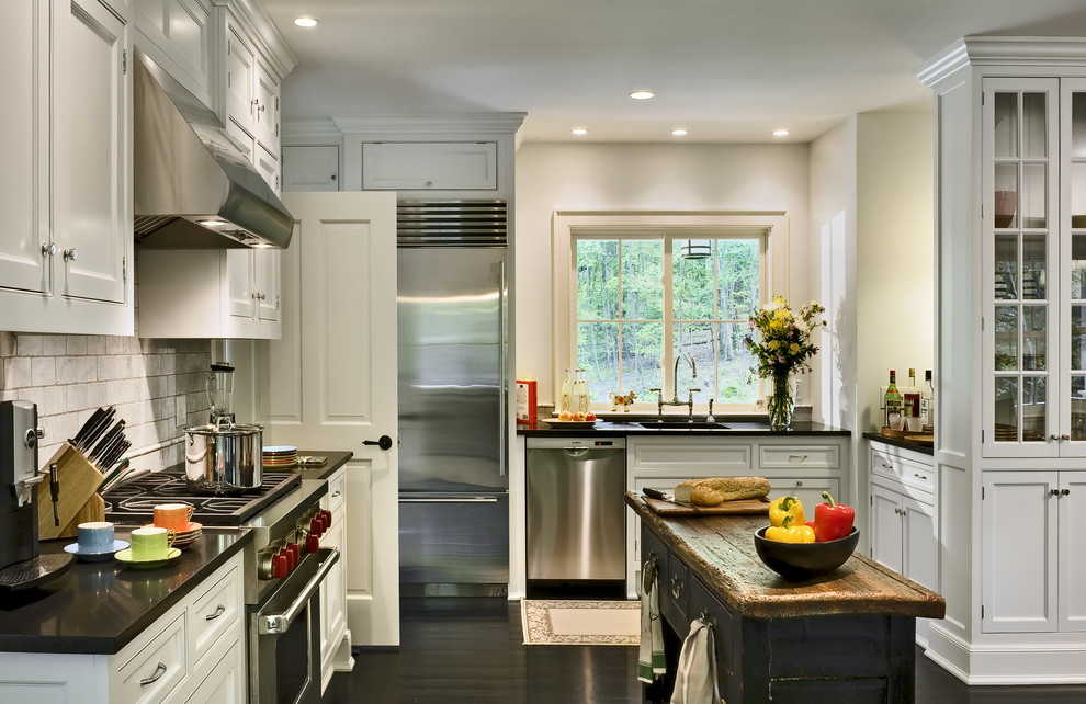 Design ideas for a traditional l-shaped eat-in kitchen in New York with recessed-panel cabinets, white cabinets, white splashback, subway tile splashback, stainless steel appliances, an undermount sink and granite benchtops.