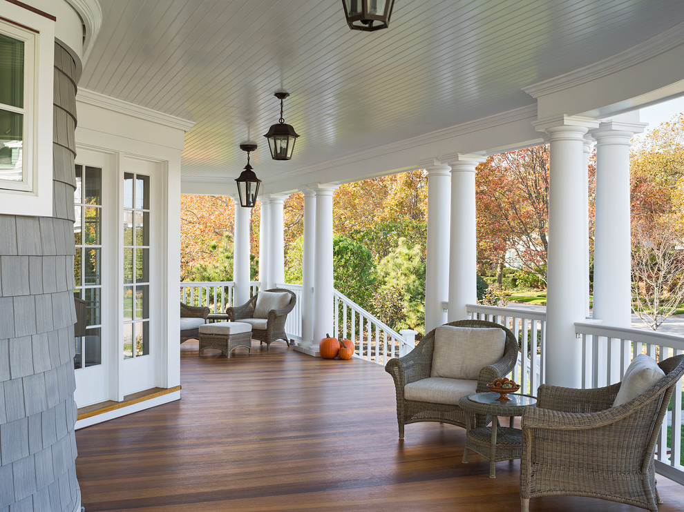 Large ornate front porch idea in New York with decking and a roof extension