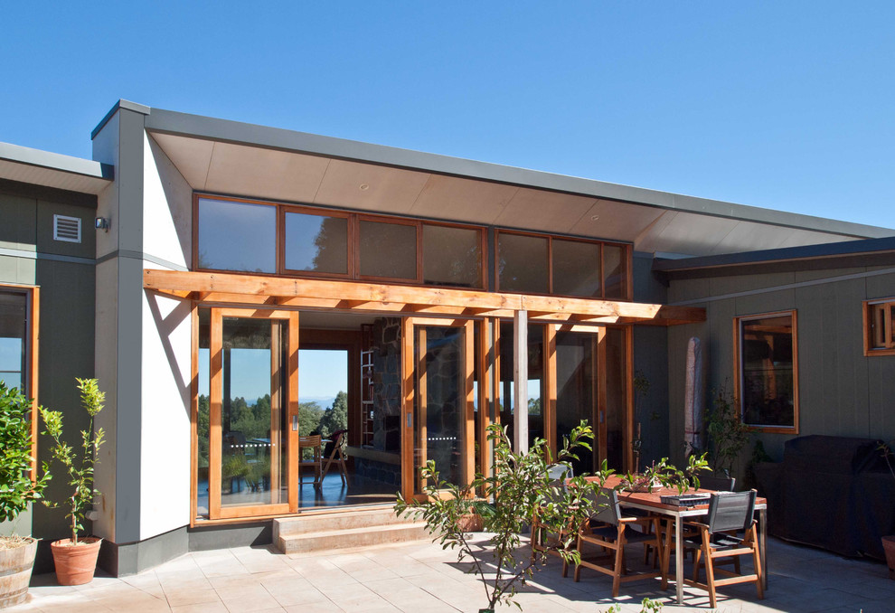 Photo of a large modern courtyard patio in Melbourne with tile and no cover.