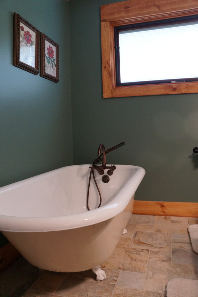 Photo of an arts and crafts bathroom in Indianapolis with a claw-foot tub, beige tile, ceramic tile and ceramic floors.