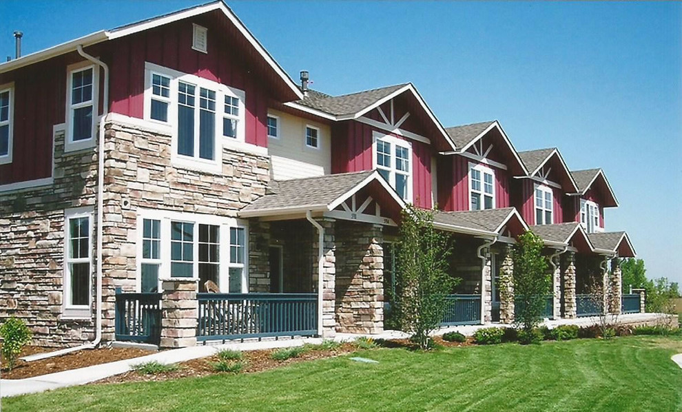 Large traditional two-storey red exterior in Denver with mixed siding.