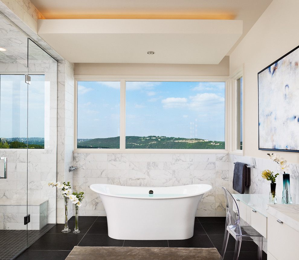 Photo of a contemporary master bathroom in Austin with a freestanding tub, a corner shower and white walls.
