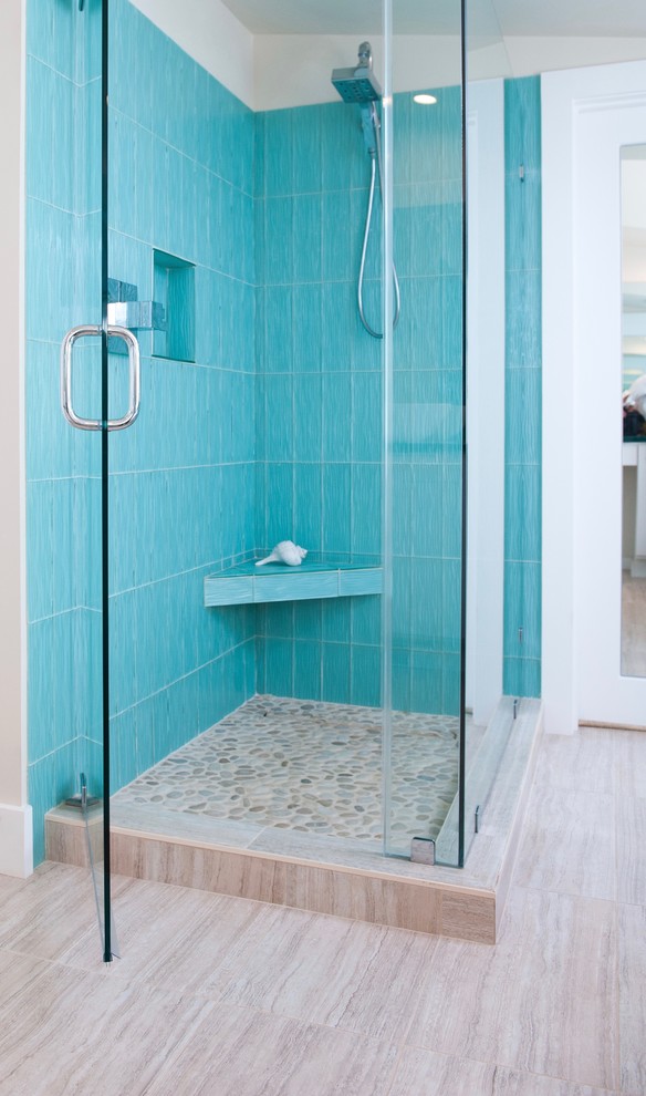 Photo of a mid-sized eclectic master bathroom in Providence with flat-panel cabinets, white cabinets, a freestanding tub, a corner shower, a one-piece toilet, blue tile, glass tile, white walls, ceramic floors, glass benchtops and a vessel sink.