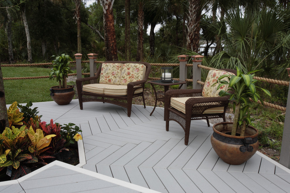Deck - mid-sized tropical backyard deck idea with no cover