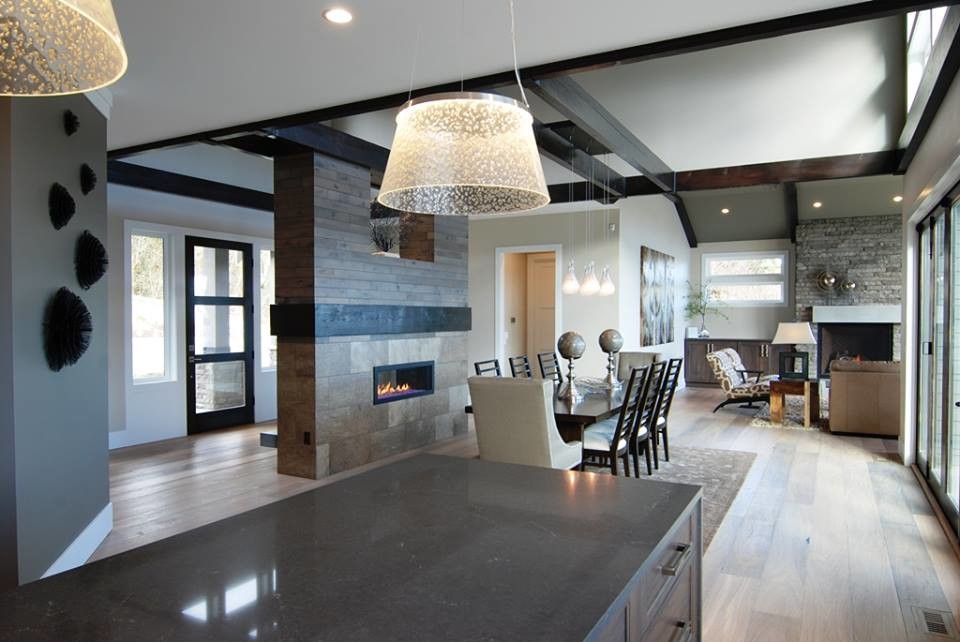 Eat-in kitchen - transitional u-shaped light wood floor eat-in kitchen idea in Seattle with recessed-panel cabinets, dark wood cabinets, granite countertops and an island
