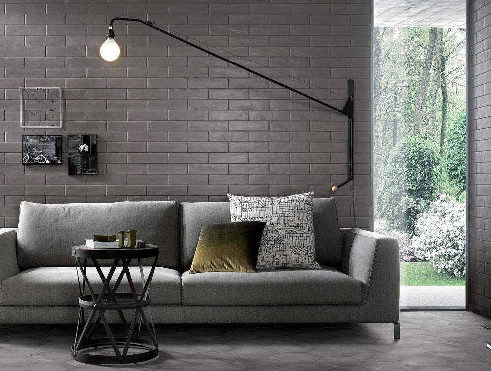 Photo of a contemporary enclosed living room in New York with grey walls and slate floors.