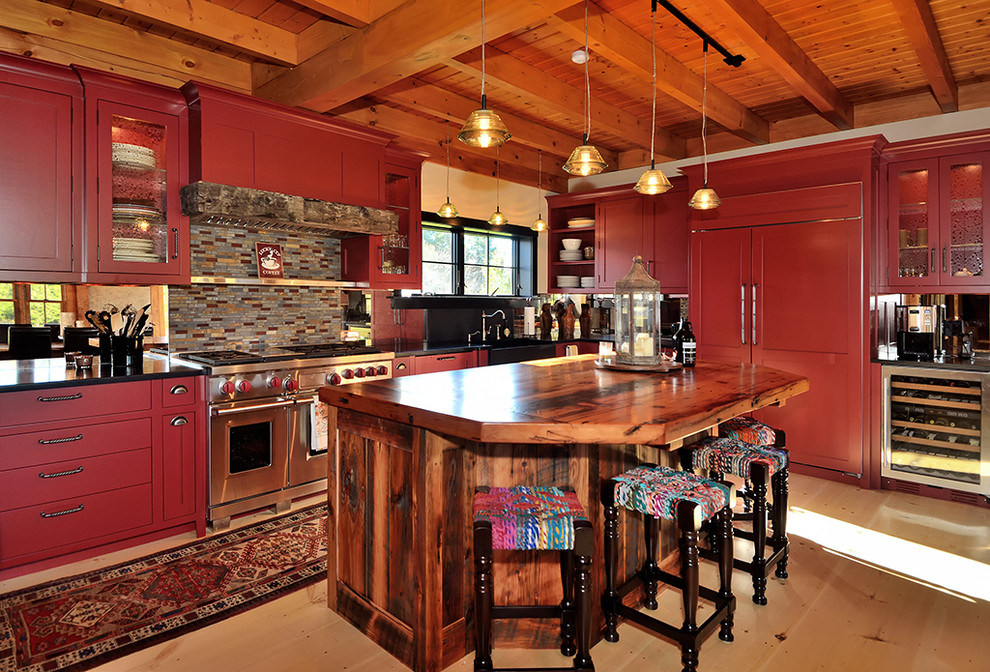 This is an example of an expansive country u-shaped eat-in kitchen in New York with red cabinets, recessed-panel cabinets, a farmhouse sink, granite benchtops, multi-coloured splashback, mosaic tile splashback, stainless steel appliances, light hardwood floors and with island.