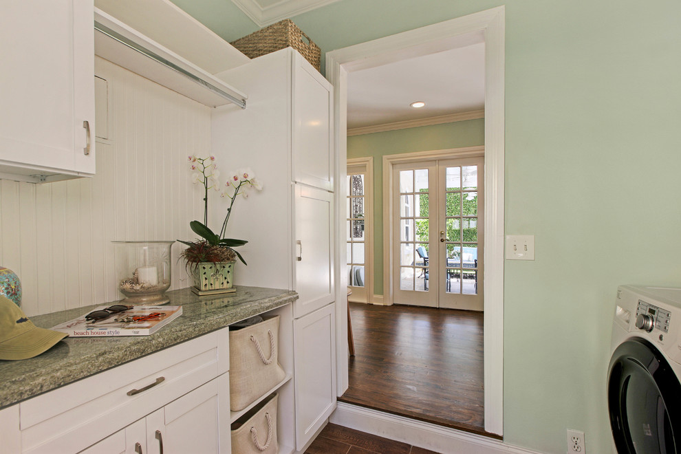 Inspiration for a traditional laundry room in Miami with shaker cabinets, white cabinets, green walls, dark hardwood floors, a side-by-side washer and dryer and green benchtop.