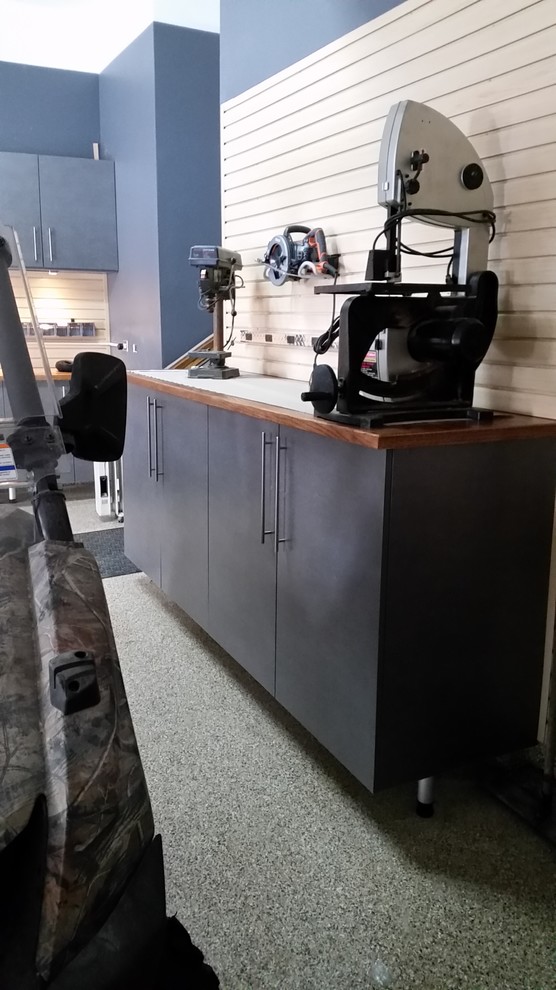 Mid-sized trendy attached two-car garage workshop photo in Chicago