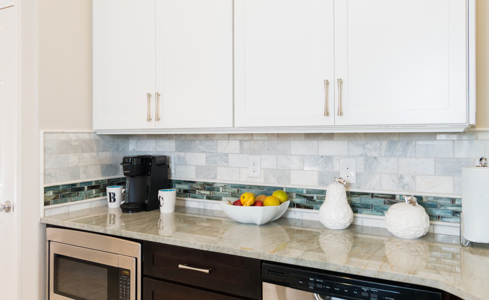 Small transitional galley ceramic tile eat-in kitchen photo in Orlando with shaker cabinets, white cabinets, quartzite countertops, gray backsplash, stone tile backsplash, stainless steel appliances and a peninsula
