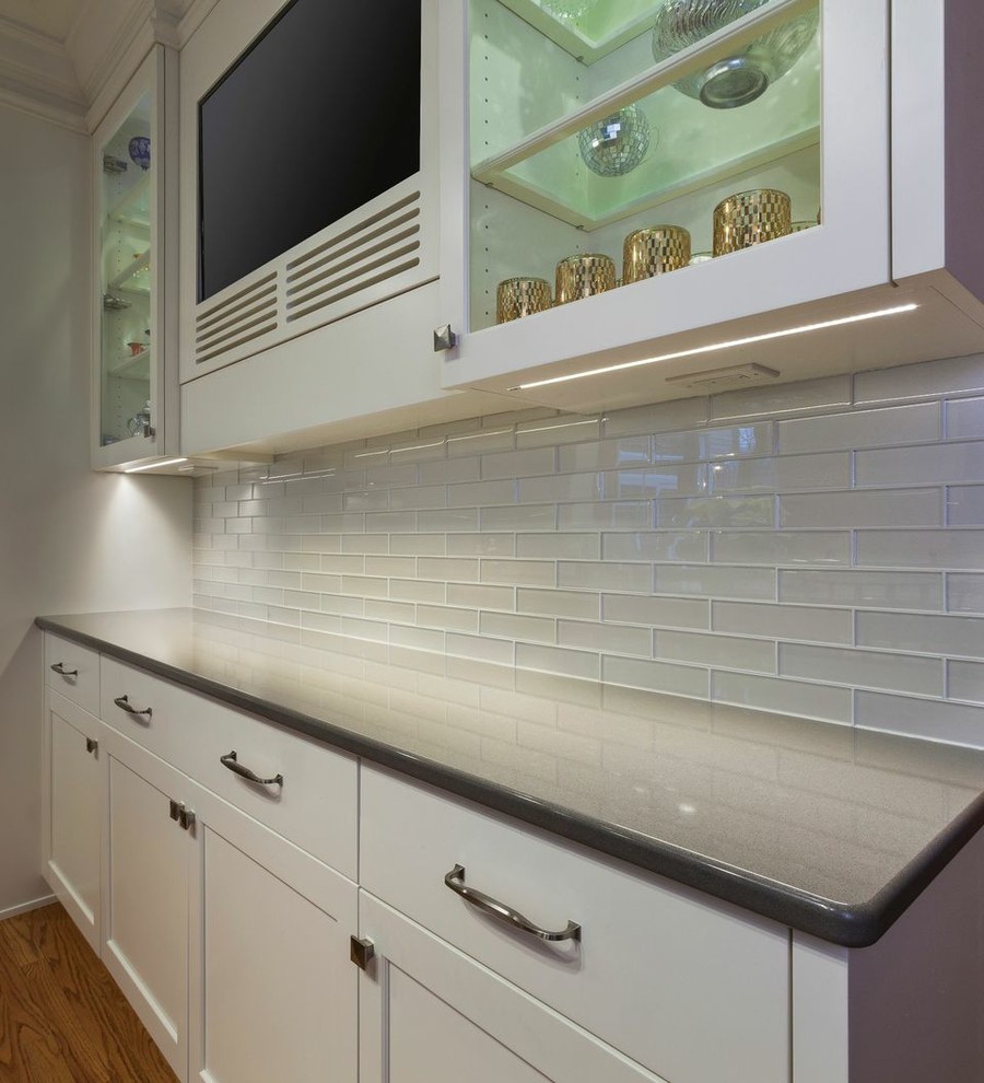 Large transitional light wood floor kitchen pantry photo in Cleveland with white backsplash, glass tile backsplash, stainless steel appliances and an island