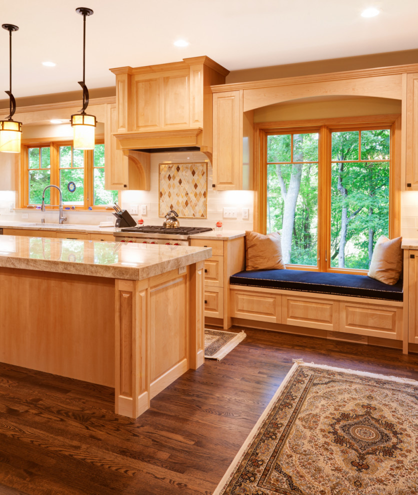 Inspiration for a large traditional l-shaped eat-in kitchen in Minneapolis with raised-panel cabinets, light wood cabinets, quartzite benchtops, beige splashback, stone tile splashback, stainless steel appliances, medium hardwood floors, with island and beige benchtop.