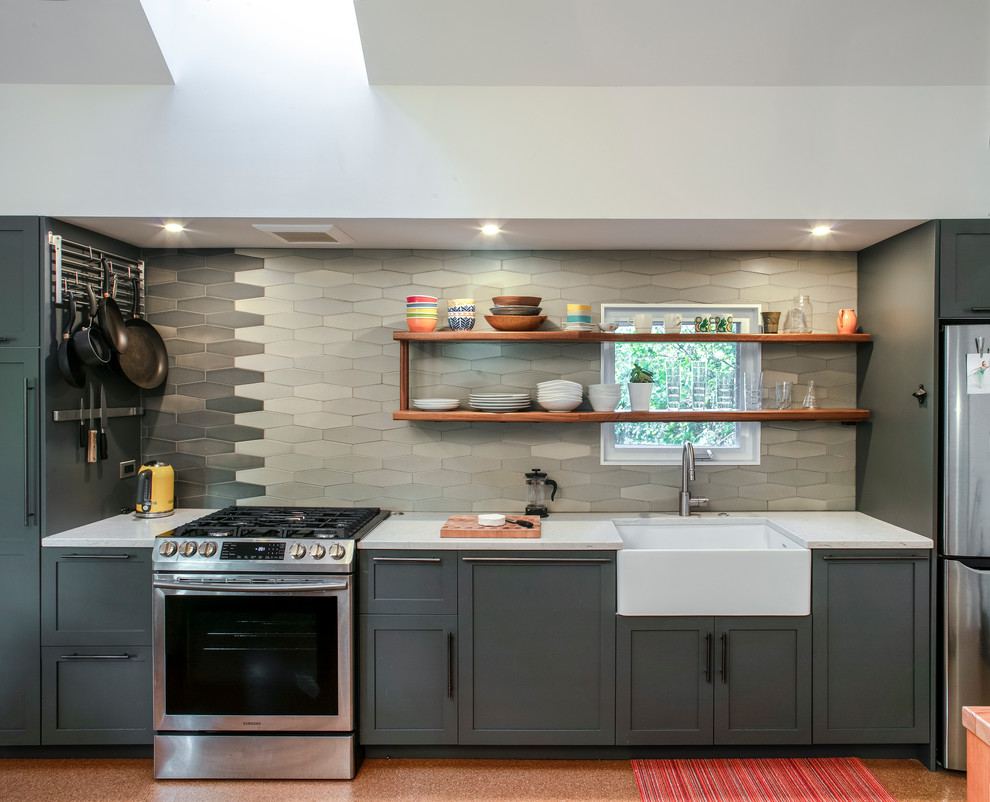 This is an example of a small modern single-wall eat-in kitchen in Portland with a farmhouse sink, shaker cabinets, grey cabinets, quartz benchtops, grey splashback, porcelain splashback, stainless steel appliances, cork floors, no island, brown floor and white benchtop.
