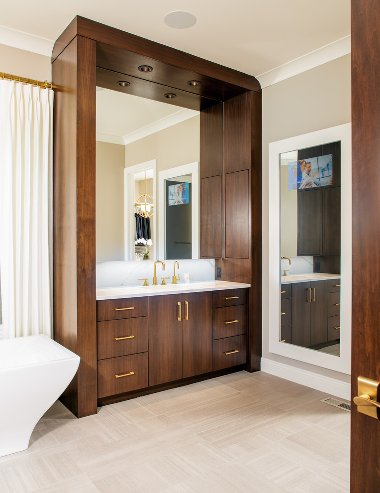 This is an example of a large contemporary master bathroom in Omaha with flat-panel cabinets, dark wood cabinets, a freestanding tub, a corner shower, white tile, marble, brown walls, porcelain floors, an undermount sink, marble benchtops, brown floor and a hinged shower door.