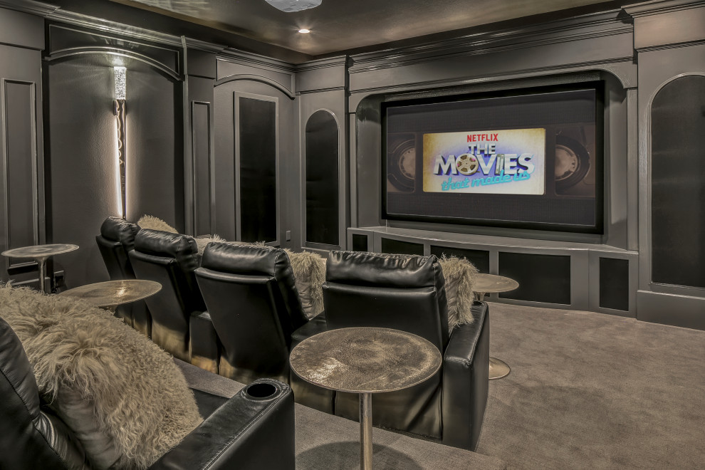 Large traditional enclosed home cinema in Tampa with grey walls, carpet, a projector screen and grey floors.
