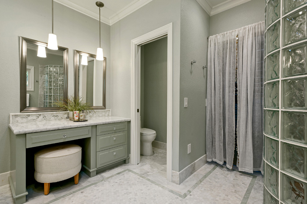 This is an example of a mid-sized modern master bathroom in San Francisco with an undermount sink, raised-panel cabinets, green cabinets, marble benchtops, a curbless shower, a one-piece toilet, white tile, stone tile, green walls and mosaic tile floors.