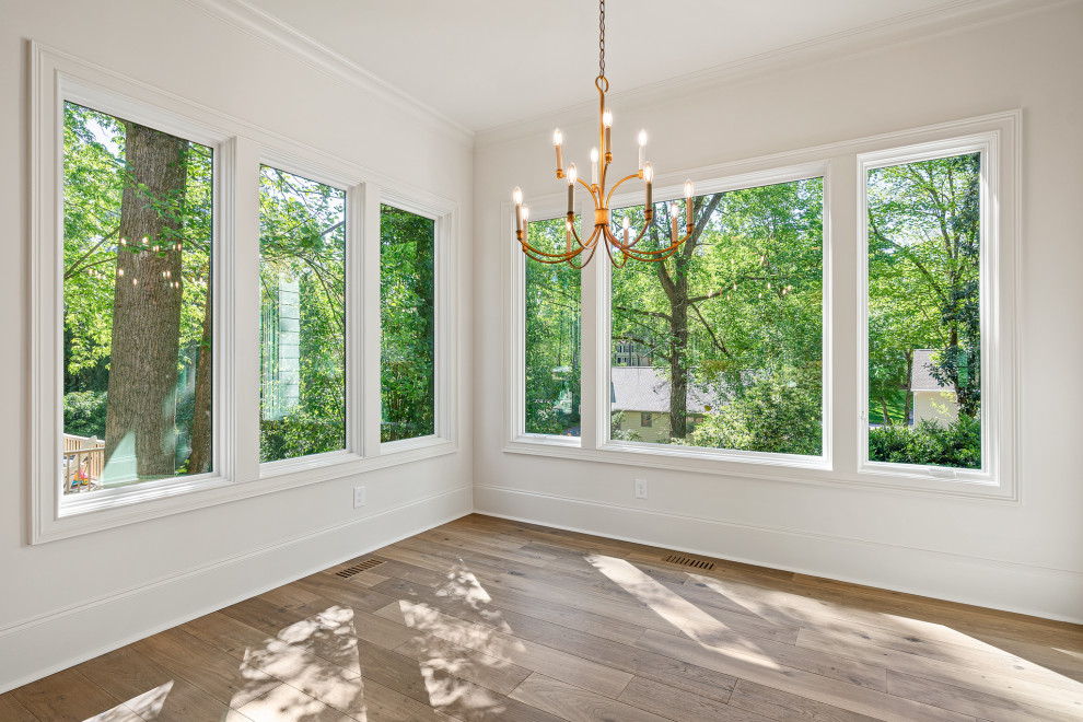 Large traditional dining room in Raleigh with white walls, medium hardwood floors and brown floor.
