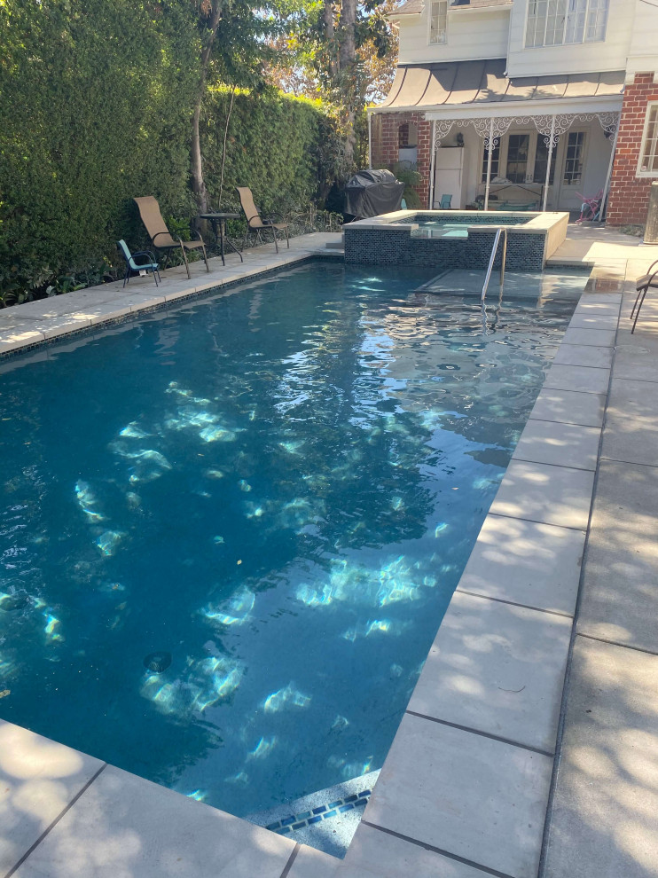 Small backyard concrete paver and rectangular lap hot tub photo