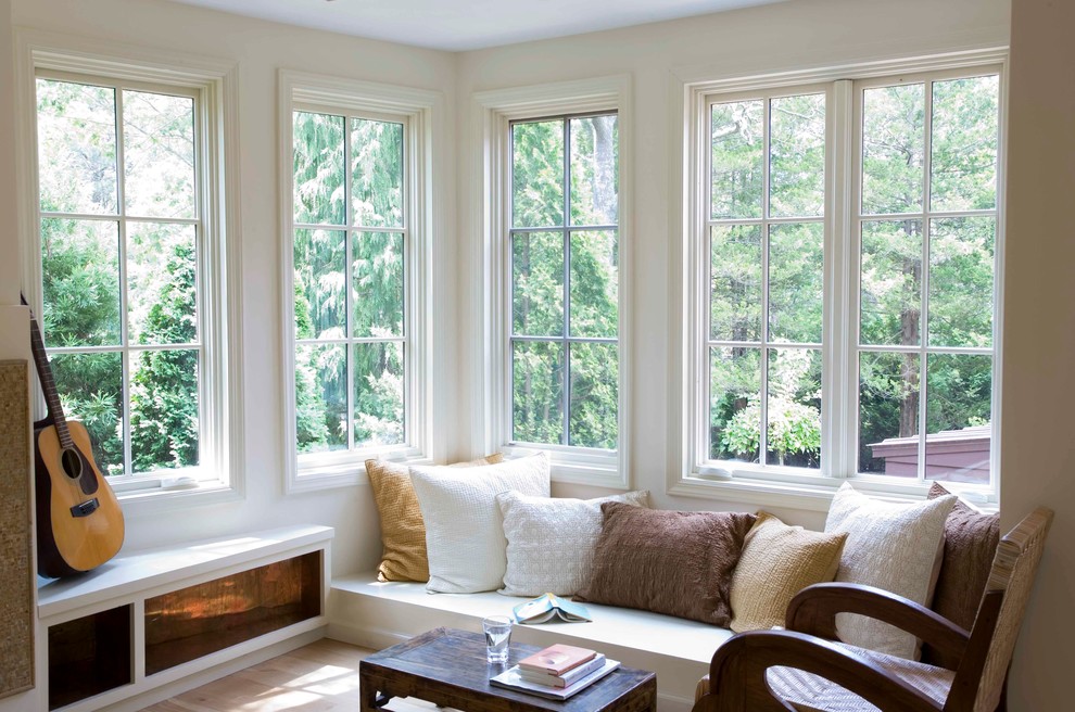 Inspiration for a transitional sunroom in New York with light hardwood floors and a standard ceiling.