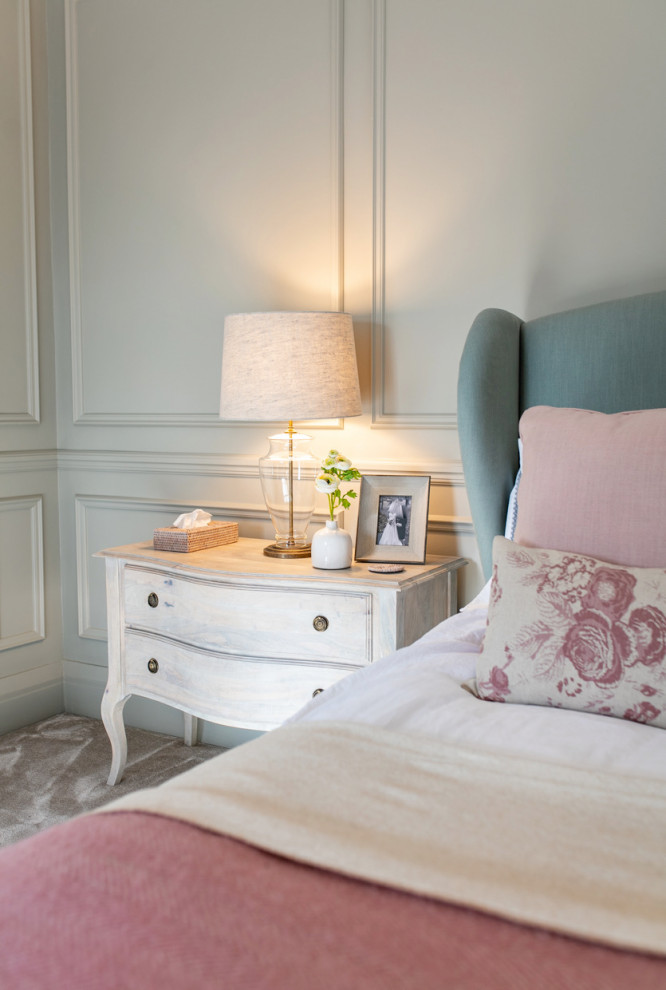 Large traditional master bedroom in Surrey with grey walls, carpet, grey floor and panelled walls.