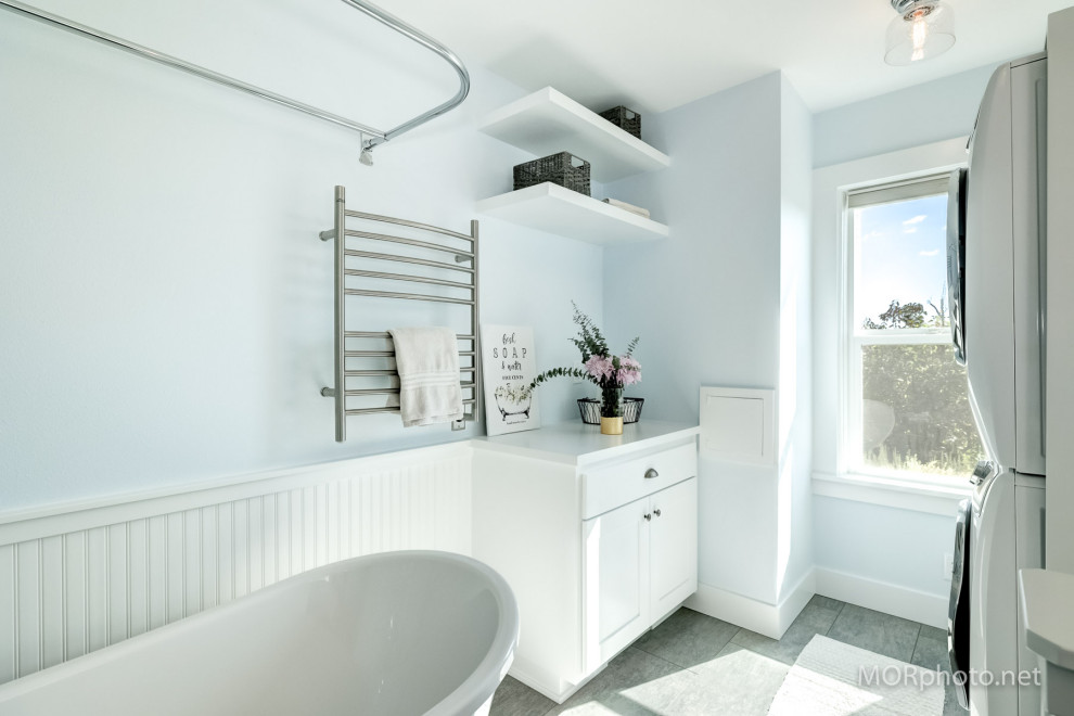 Inspiration for a mid-sized cottage vinyl floor, gray floor, single-sink and wainscoting bathroom remodel in Portland with shaker cabinets, white cabinets, a bidet, blue walls, an undermount sink, granite countertops, white countertops and a built-in vanity