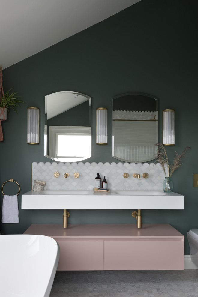 Design ideas for a mid-sized eclectic master bathroom in Kent with a freestanding tub, an open shower, a wall-mount toilet, green walls, marble floors, solid surface benchtops, an open shower, white benchtops, a niche, a double vanity, a floating vanity and vaulted.