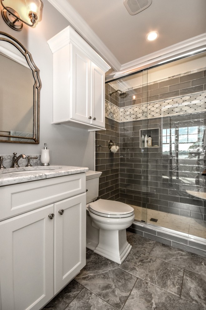Inspiration for a large traditional 3/4 bathroom in Charlotte with recessed-panel cabinets, white cabinets, an alcove shower, a two-piece toilet, grey walls, an undermount sink, granite benchtops and a sliding shower screen.