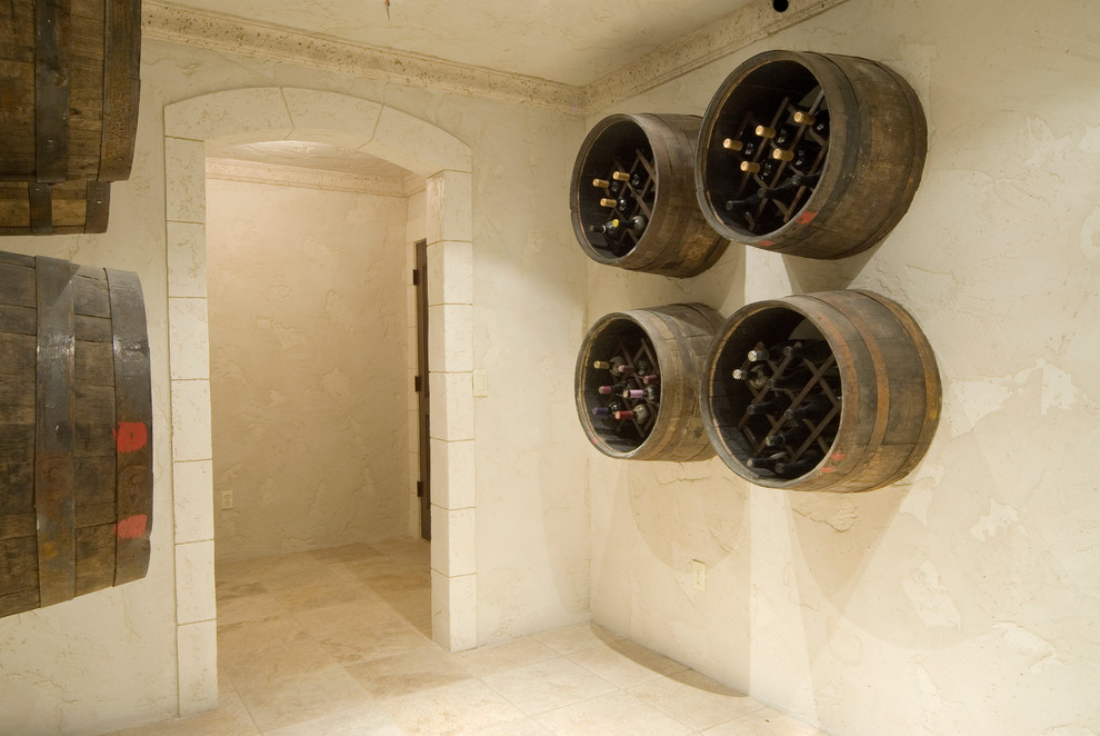 Inspiration for a large traditional wine cellar in Other with travertine floors and diamond bins.