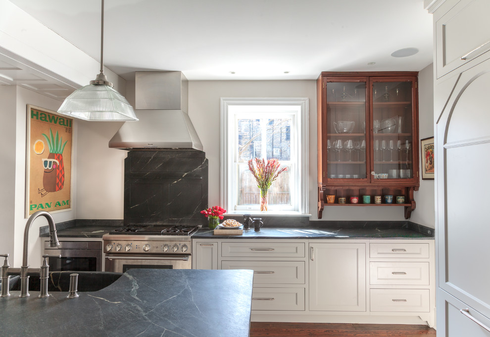This is an example of a large transitional eat-in kitchen in Philadelphia with an integrated sink, recessed-panel cabinets, white cabinets, soapstone benchtops, stainless steel appliances, dark hardwood floors, with island and brown floor.