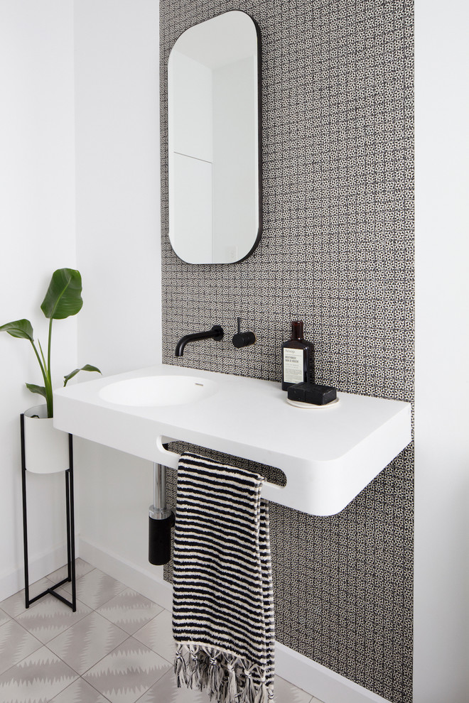 Inspiration for a contemporary master bathroom in Brisbane with flat-panel cabinets, light wood cabinets, a freestanding tub, a curbless shower, a two-piece toilet, gray tile, white walls, cement tiles and a vessel sink.