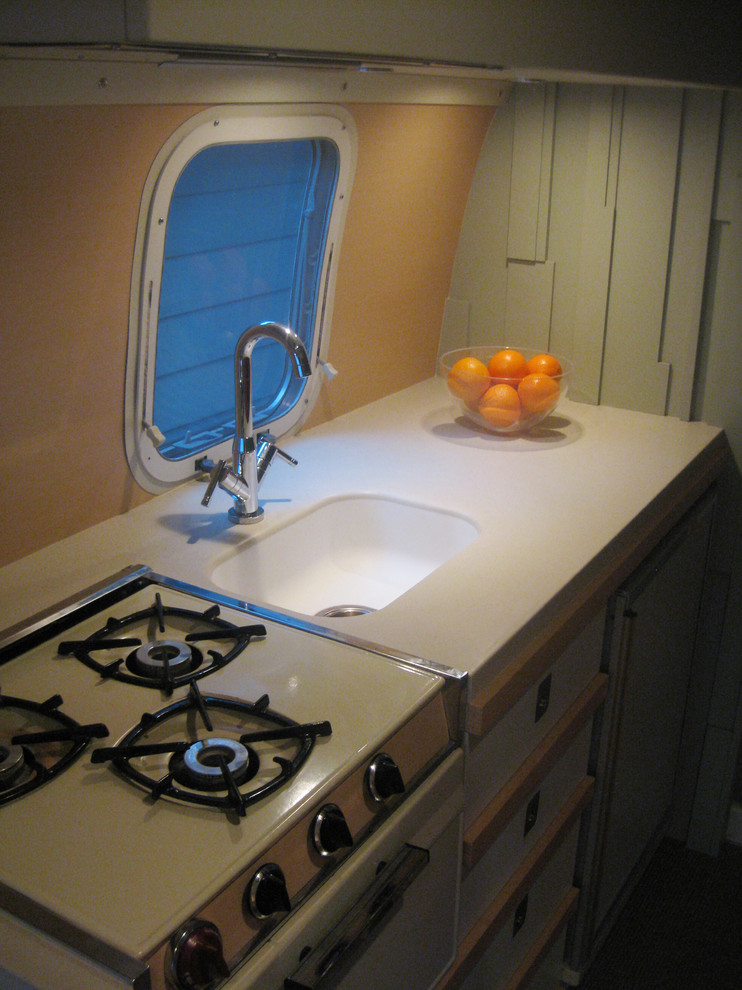 This is an example of a midcentury kitchen in Other with an integrated sink.