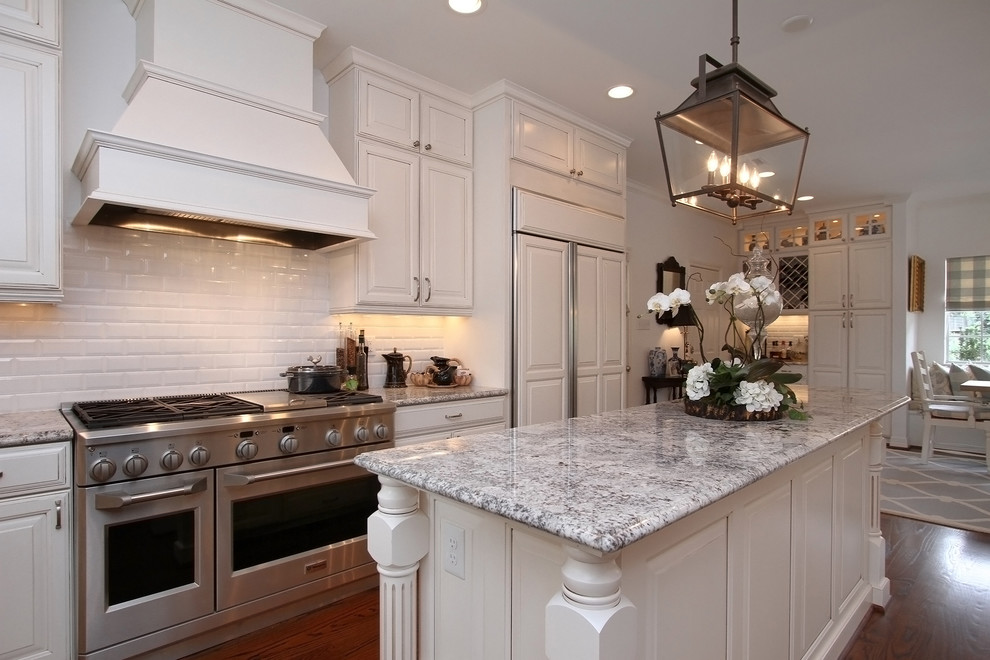 Inspiration for a timeless u-shaped eat-in kitchen remodel in Houston with raised-panel cabinets, white cabinets, white backsplash, subway tile backsplash and stainless steel appliances