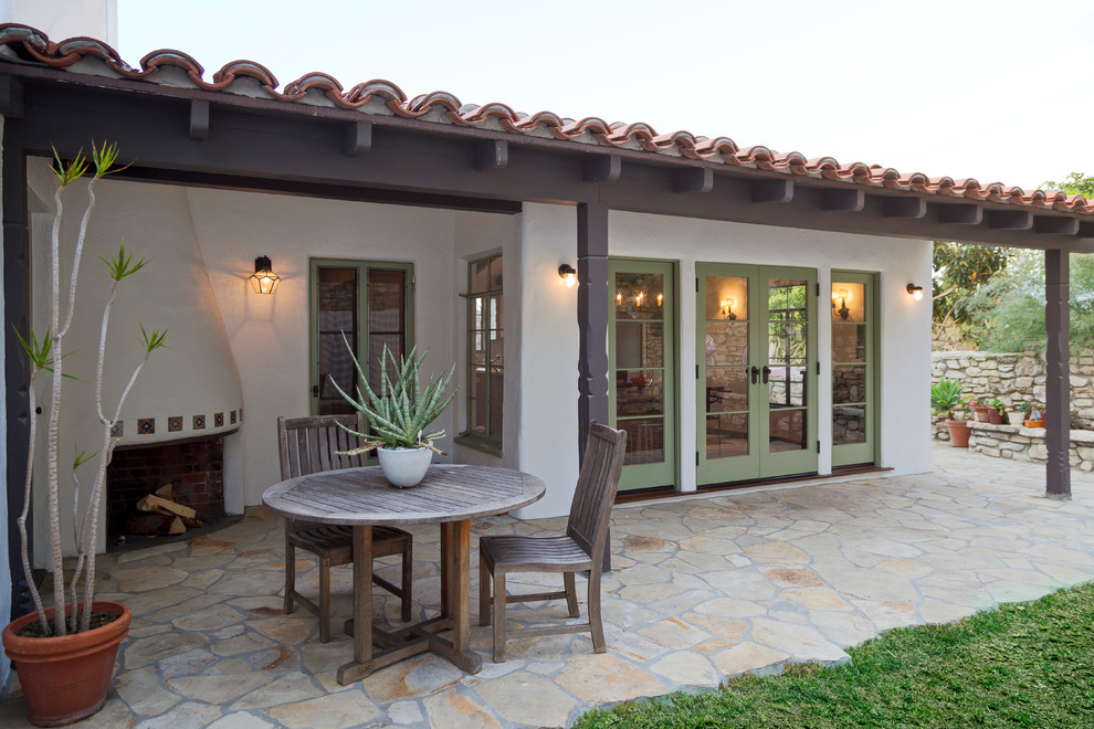 This is an example of a mediterranean patio in Los Angeles with a fire feature.
