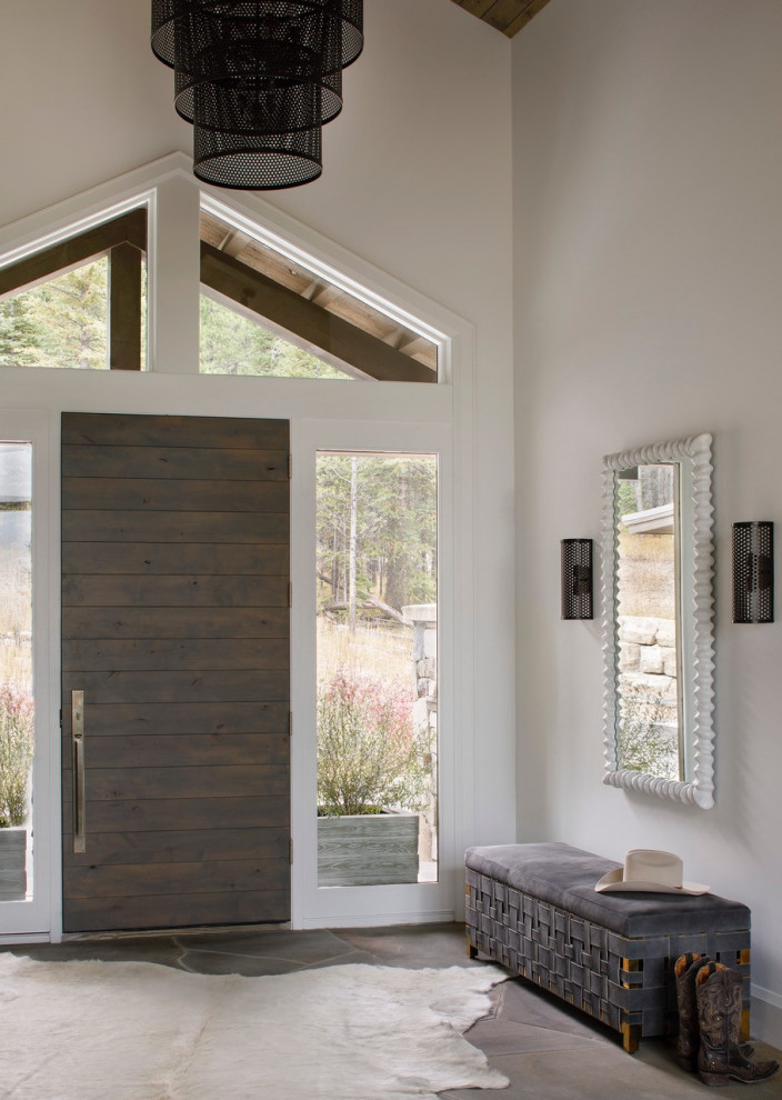 Foyer - rustic marble floor, brown floor and vaulted ceiling foyer idea with white walls and a dark wood front door
