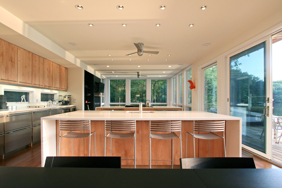 Design ideas for a modern kitchen in New York with flat-panel cabinets and light wood cabinets.