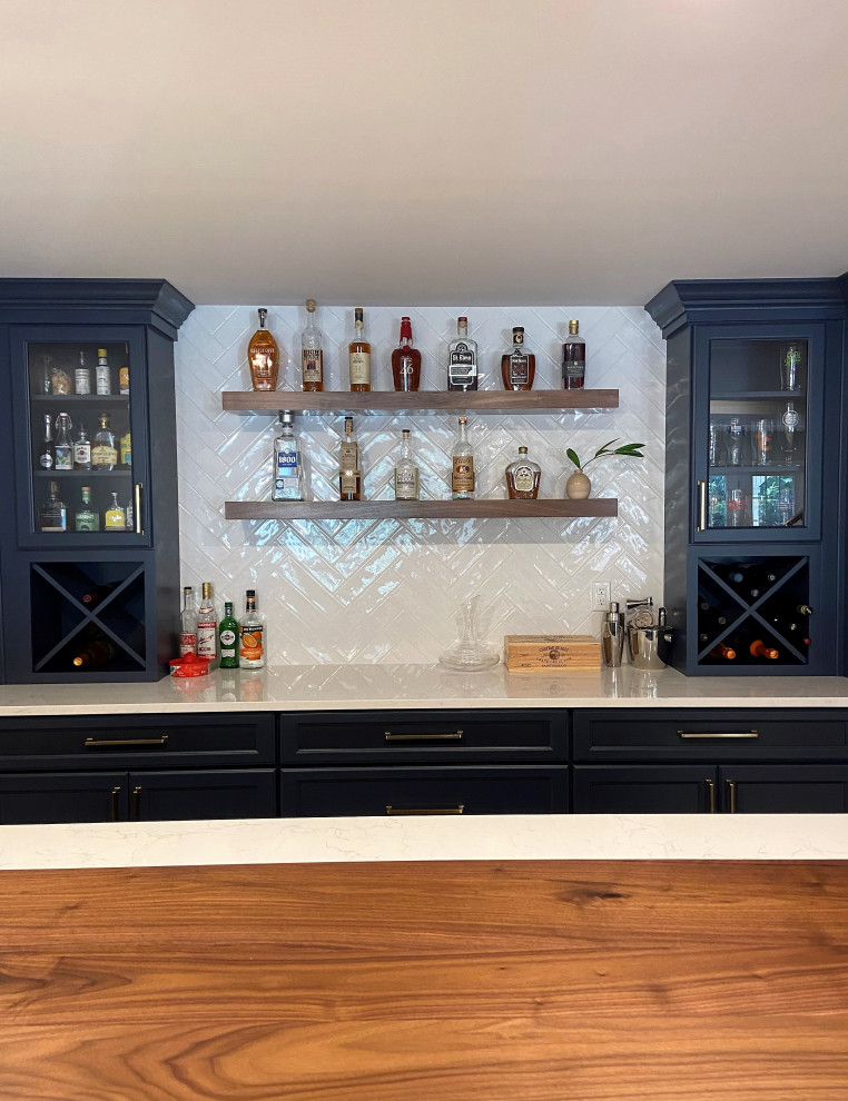 Inspiration for a mid-sized galley medium tone wood floor and brown floor wet bar remodel in Other with an undermount sink, floating shelves, blue cabinets, wood countertops, white backsplash, subway tile backsplash and white countertops