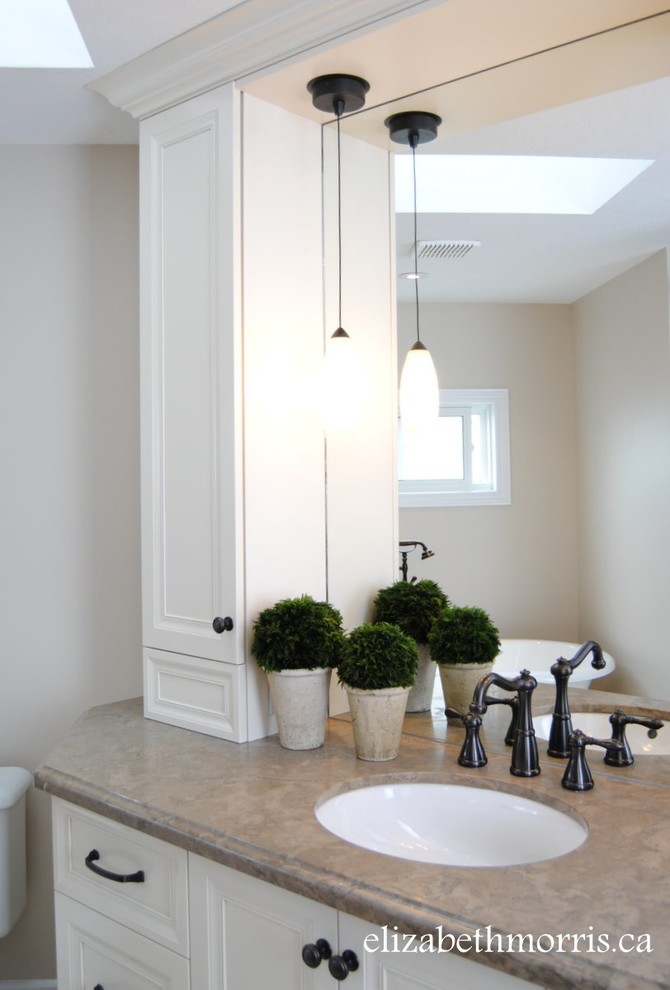 Design ideas for a small transitional master bathroom in Toronto with an undermount sink, recessed-panel cabinets, white cabinets, granite benchtops, a freestanding tub, a corner shower, a two-piece toilet, brown tile, porcelain tile, beige walls and limestone floors.
