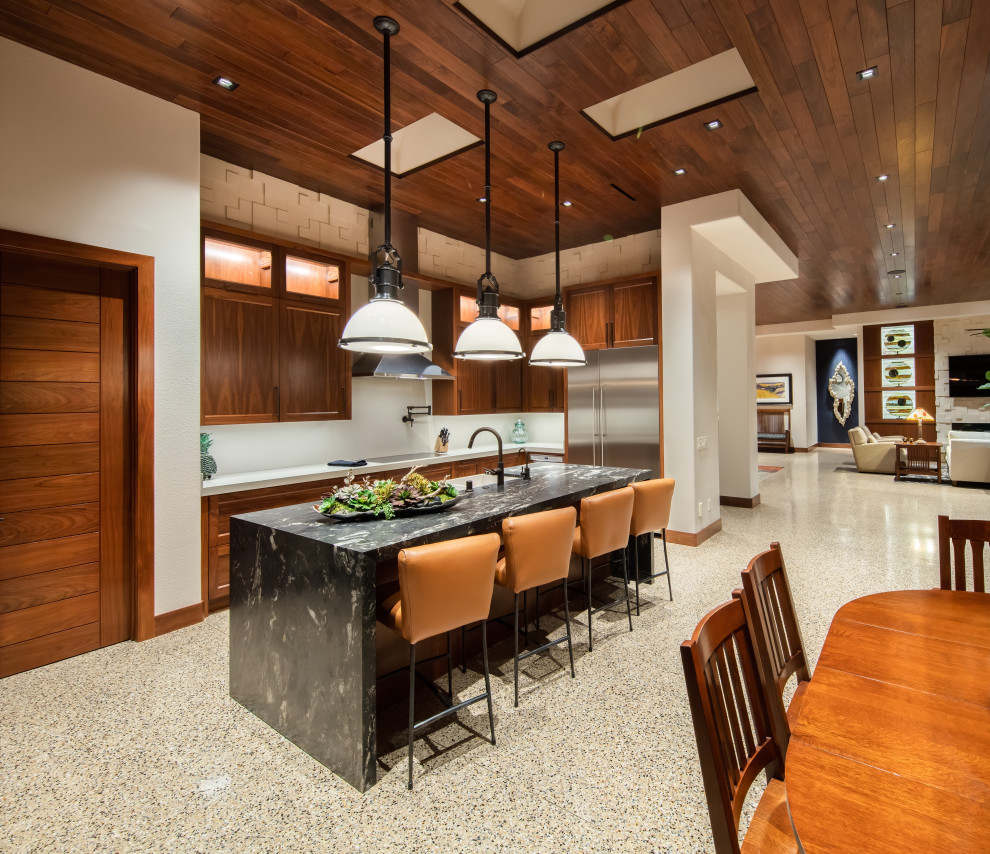 This is an example of a large transitional l-shaped open plan kitchen in Las Vegas with a farmhouse sink, shaker cabinets, marble benchtops, grey splashback, engineered quartz splashback, stainless steel appliances, terrazzo floors, with island, multi-coloured floor, multi-coloured benchtop, medium wood cabinets and wood.