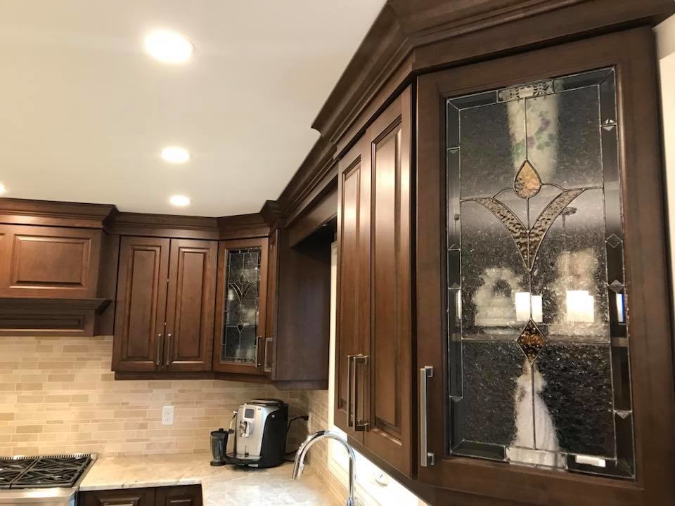 Transitional u-shaped marble floor and beige floor eat-in kitchen photo with an undermount sink, raised-panel cabinets, beige cabinets, quartzite countertops, beige backsplash, marble backsplash, stainless steel appliances and an island