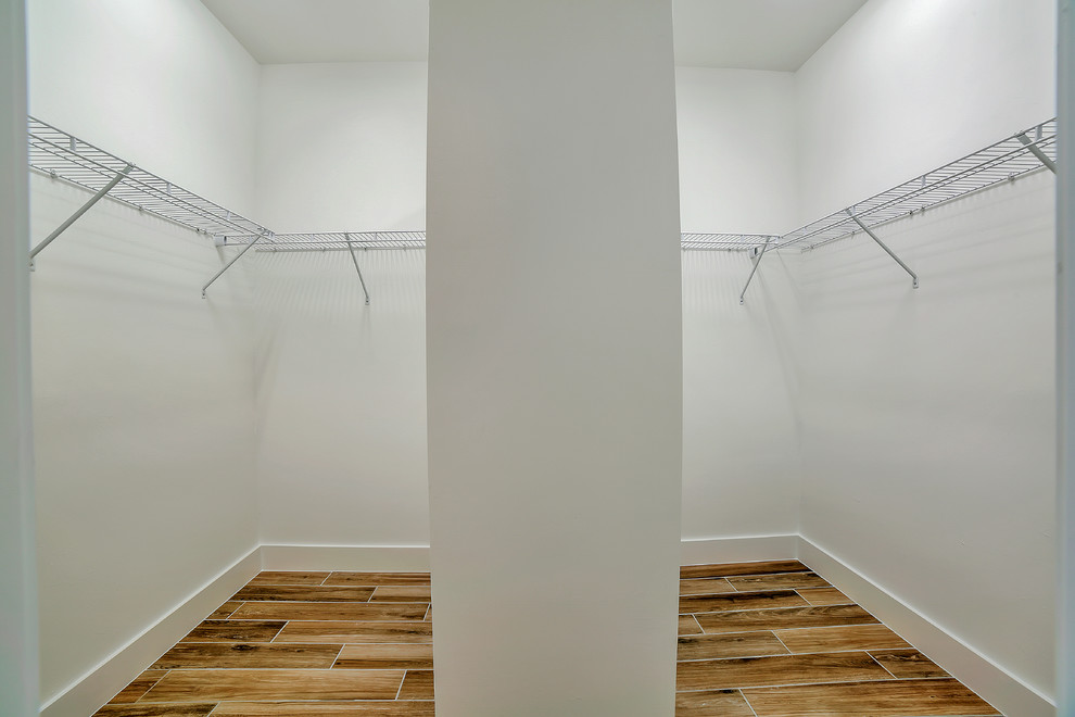 Reach-in closet - mid-sized transitional gender-neutral porcelain tile reach-in closet idea