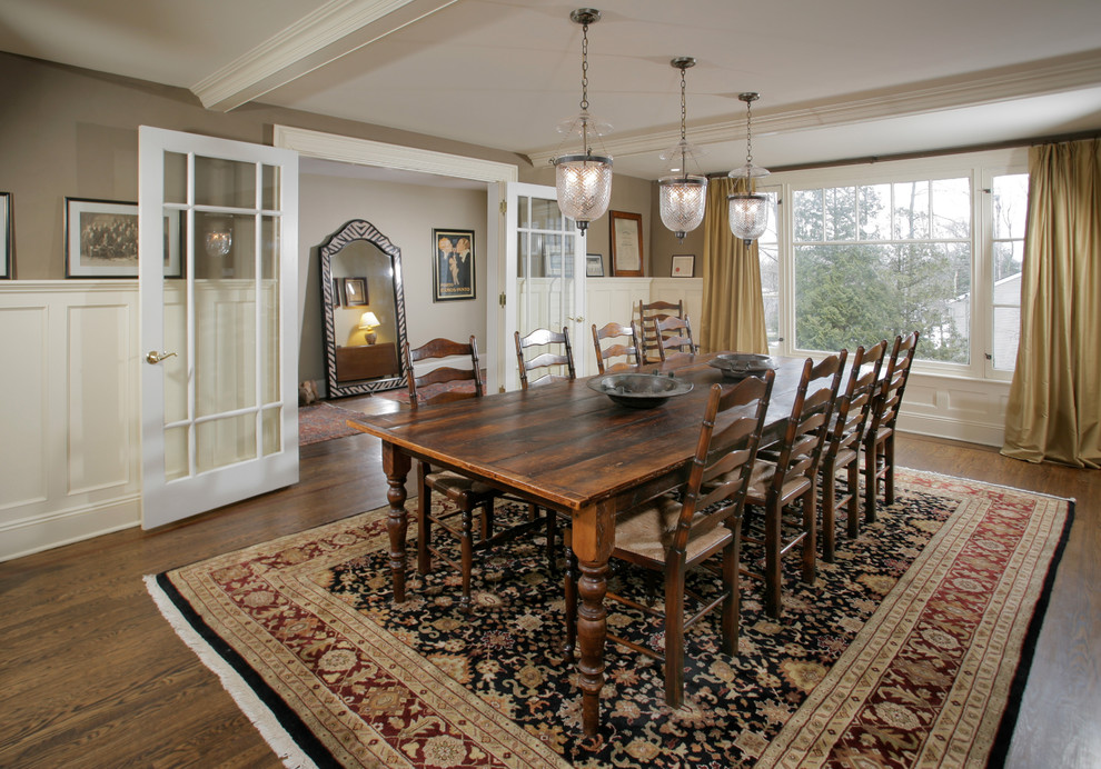 Traditional dining room in New York with dark hardwood floors.