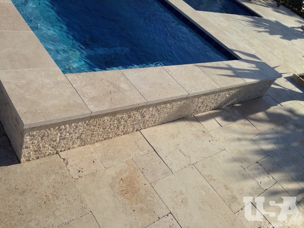 Pool - large rustic stone aboveground pool idea in Miami