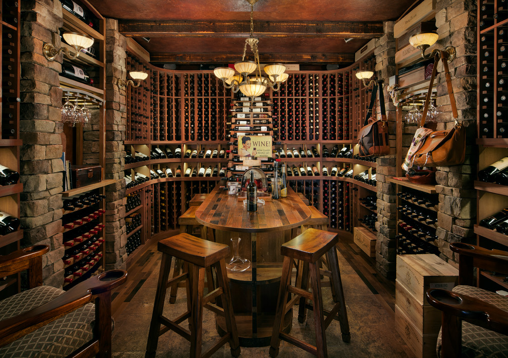 Photo of a mid-sized country wine cellar in Phoenix with storage racks, slate floors and beige floor.