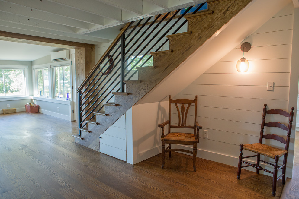 This is an example of a country wood straight staircase in Boston with metal railing.