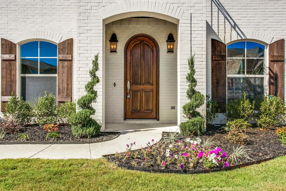 Design ideas for a traditional front door in Dallas with a single front door and a dark wood front door.