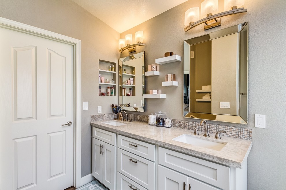 Freestanding bathtub - mid-sized transitional master white tile porcelain tile and beige floor freestanding bathtub idea in Phoenix with shaker cabinets, white cabinets, gray walls, an undermount sink, quartz countertops, a hinged shower door and white countertops