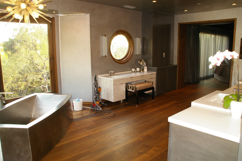 This is an example of a large industrial master bathroom in Los Angeles with flat-panel cabinets.