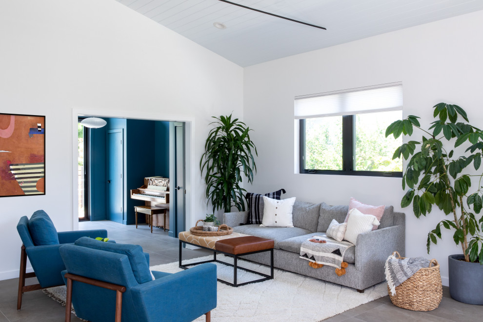 This is an example of a mid-sized midcentury formal open concept living room in San Francisco with white walls, porcelain floors, no fireplace, a built-in media wall, grey floor and timber.