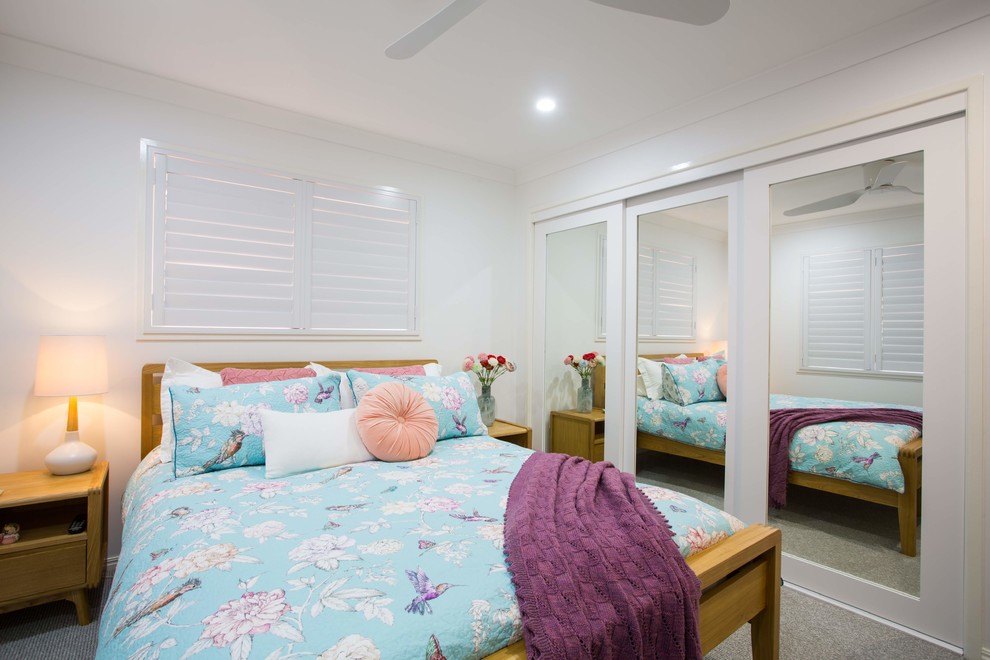 Mid-sized modern master bedroom in Brisbane with white walls, carpet and grey floor.